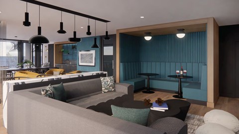 a living room and kitchen with blue walls and a gray couch