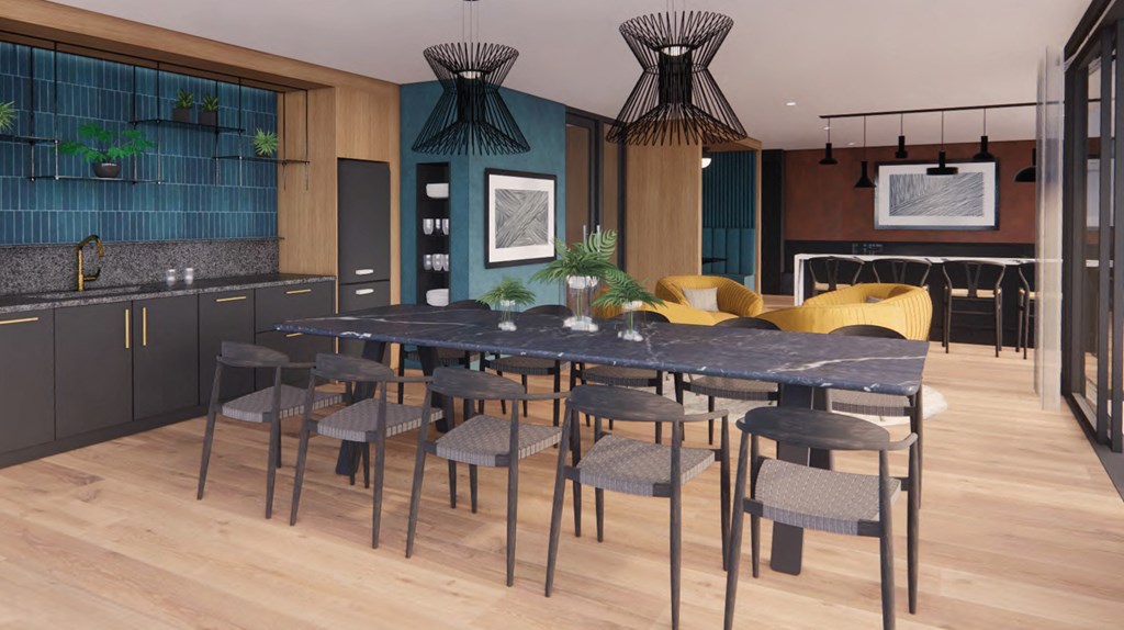 a dining room with a table and chairs and a kitchen with blue cabinets