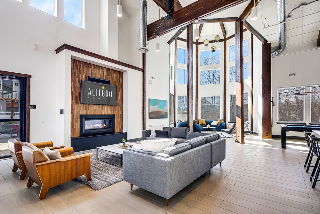 a living room with a fireplace and a large window
