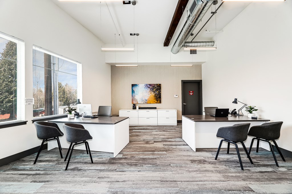 a living room with a kitchen and a table and chairs