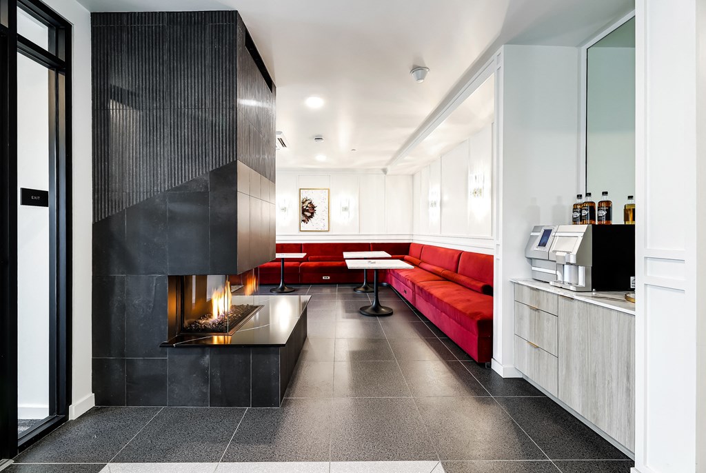 a living room with red couches and a fireplace