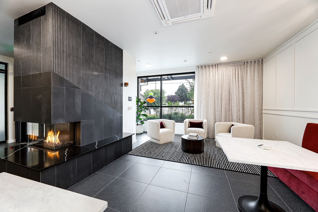a living room with a fireplace and a table and chairs