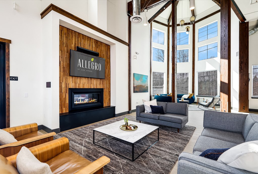 a living room with couches and a coffee table and a fireplace