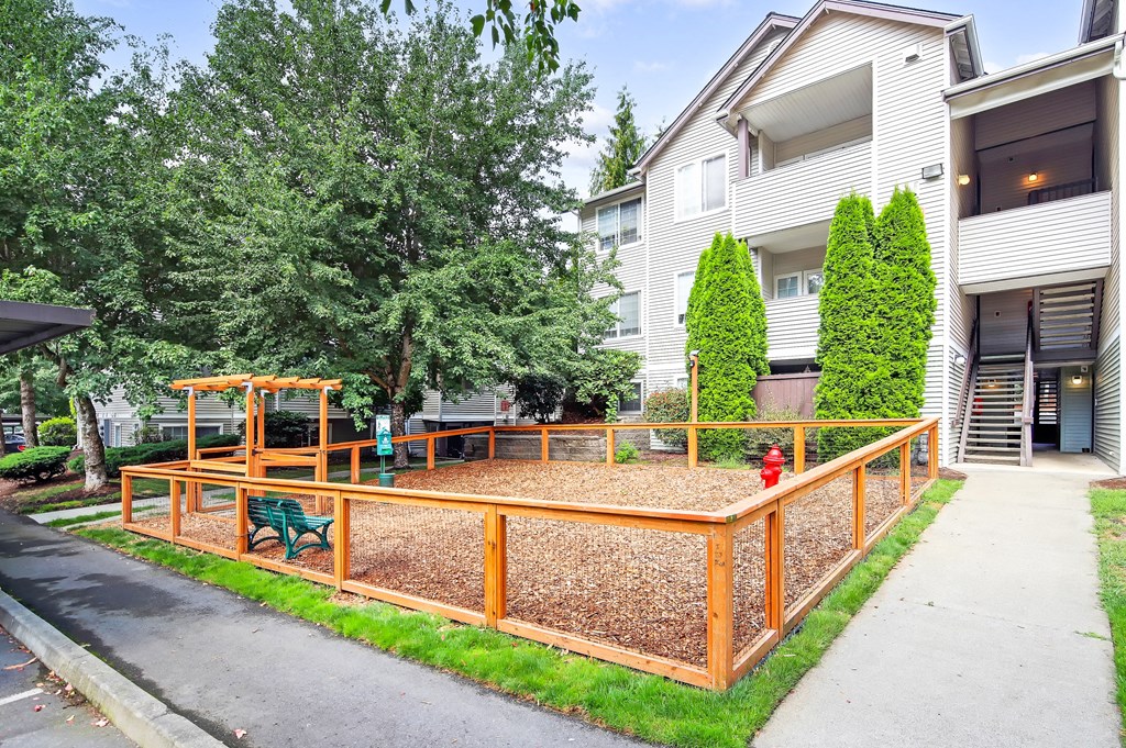 a yard with a wooden deck and a fire hydrant