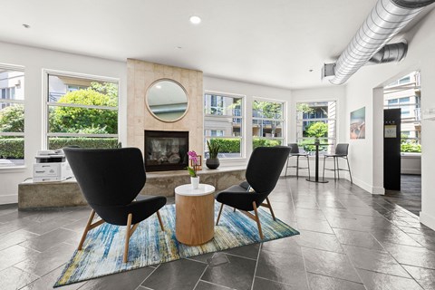a living room with a fireplace and a table with two chairs
