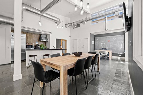 A modern kitchen with a dining table and chairs.