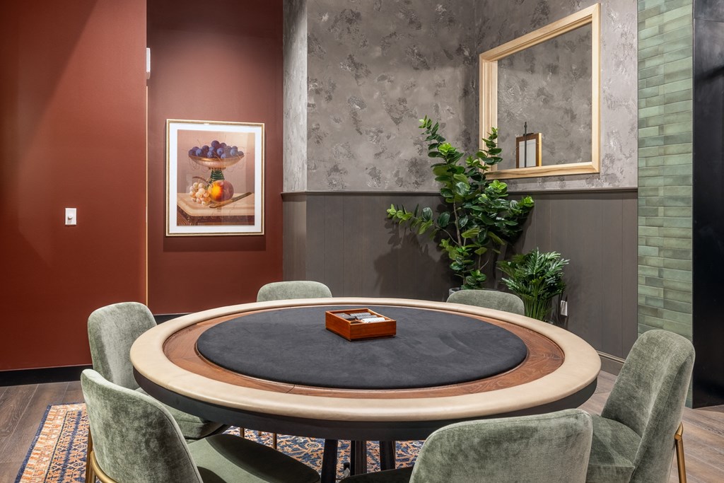 a dining room with a round table and chairs