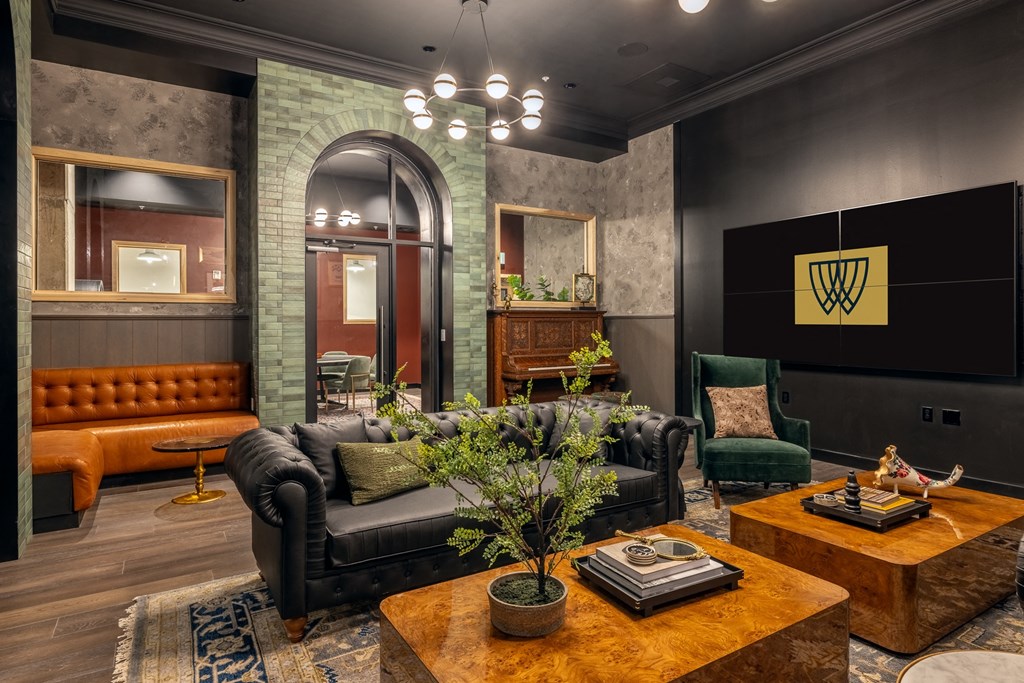 a living room with leather furniture and a tv