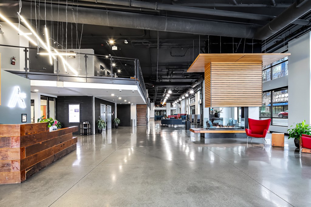 the lobby of a large office space with chairs and desks