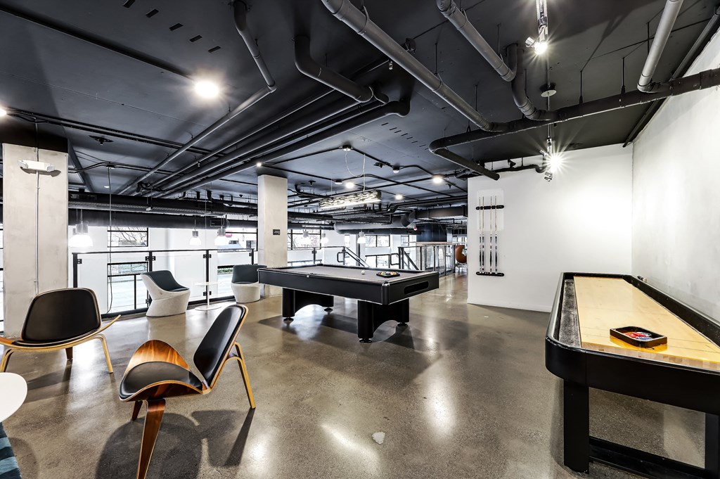 a game room with a pool table and ping pong