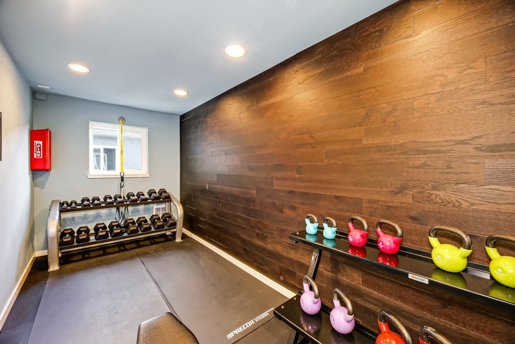 the gym has a wall of reclaimed wood and a rack of shoes