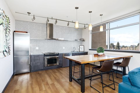 A kitchen with a wooden table and chairs.