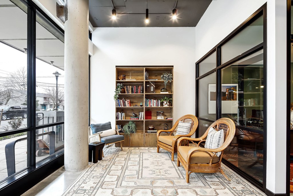 a living room with two chairs and a large window