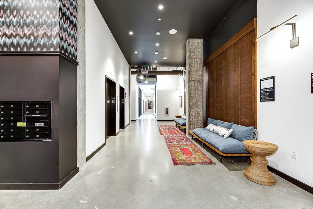 a long hallway with a couch and a fire place