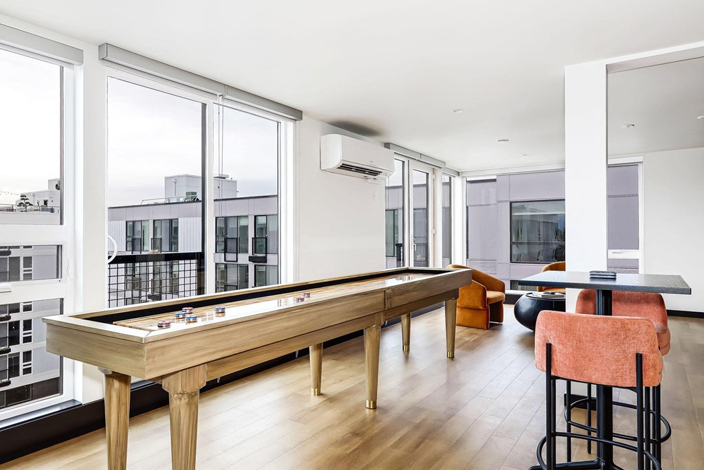 a pool table in a living room with large windows