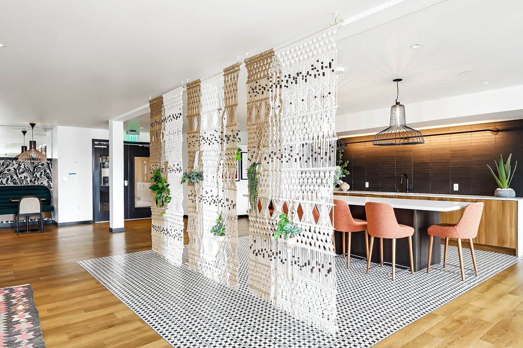 a dining room with a table and chairs and a white curtain