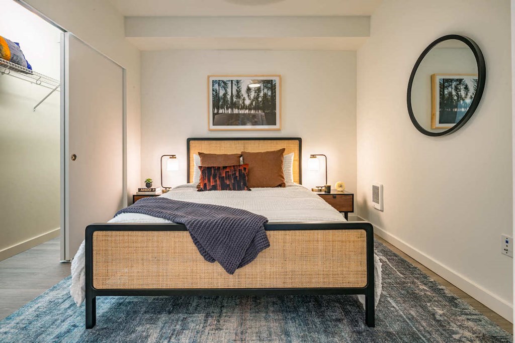 a bedroom with a bed and a mirror