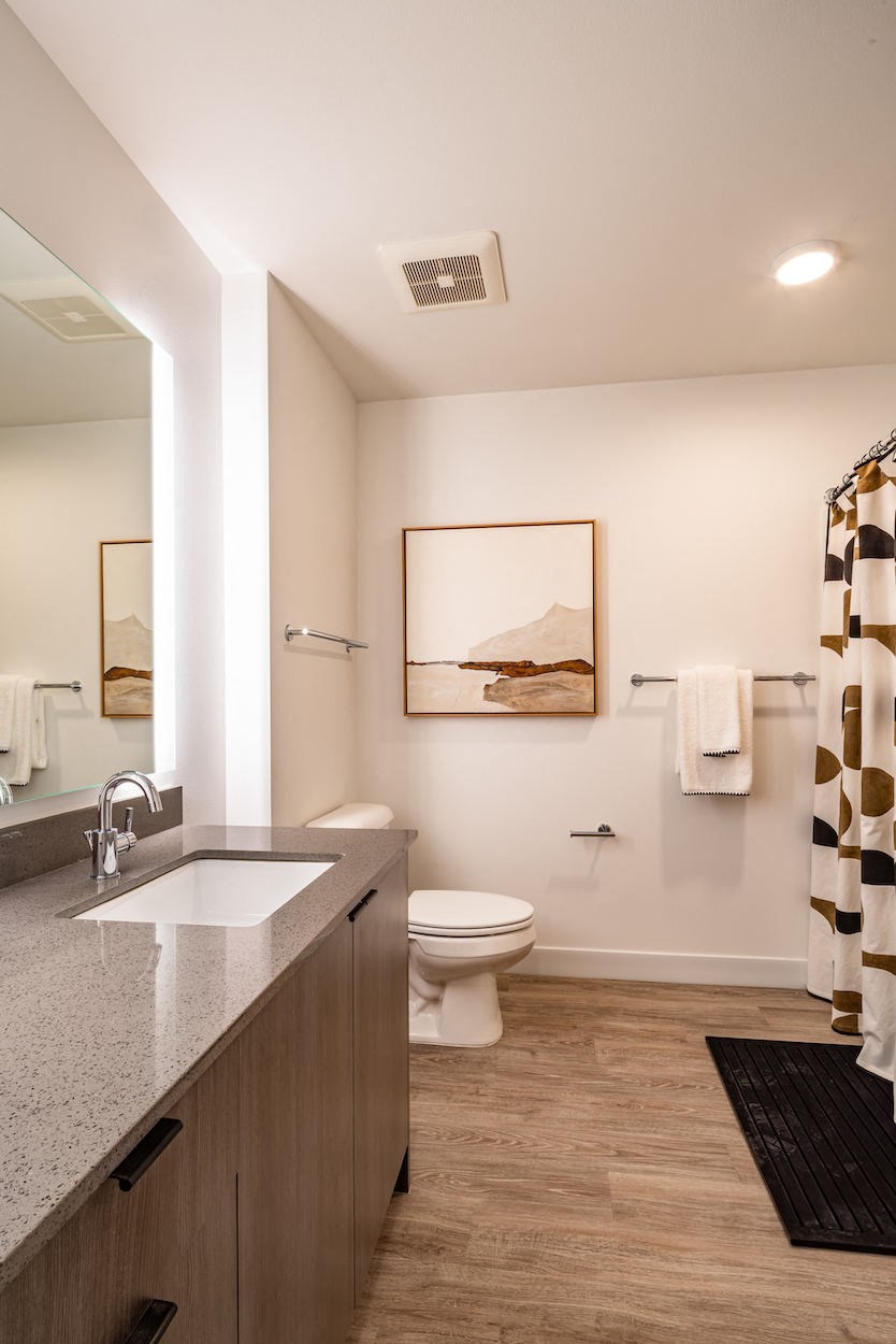 a bathroom with a toilet and a sink and a mirror