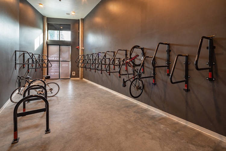 a room with a row of bikes on the wall