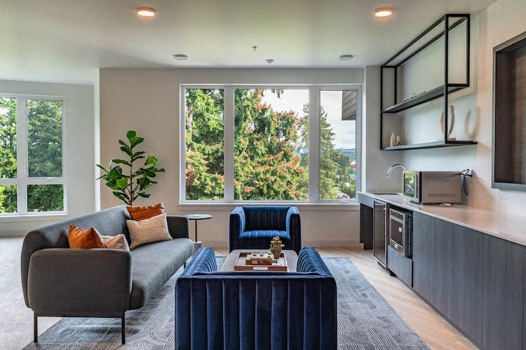 a living room with a couch and chairs and a television