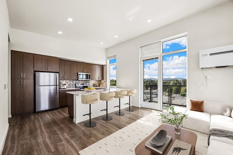 A modern kitchen with a dining table and chairs.