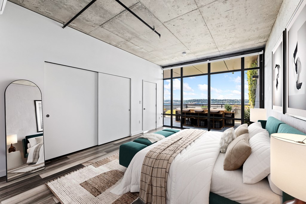 a bedroom with a large bed and a large window