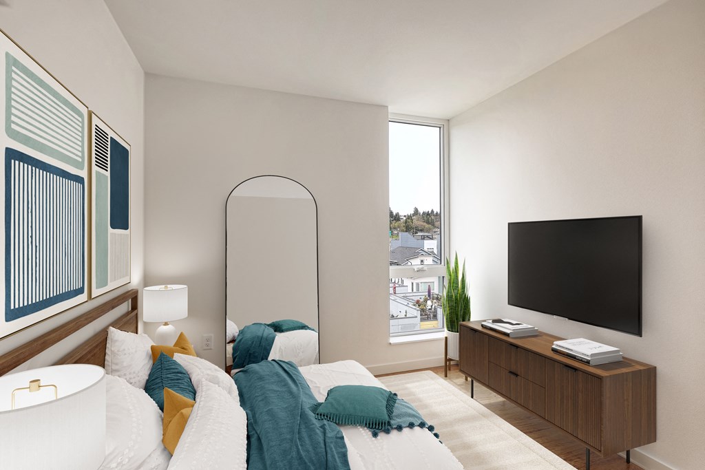 a bedroom with a bed and a tv on the wall