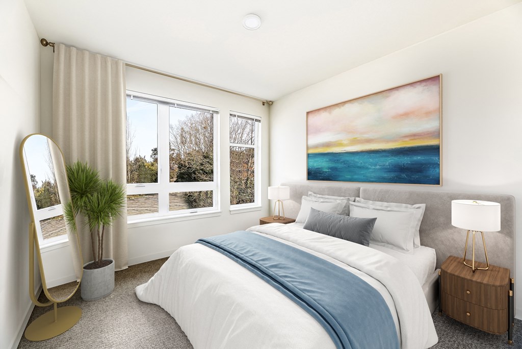 a bedroom with a large window and a large painting on the wall