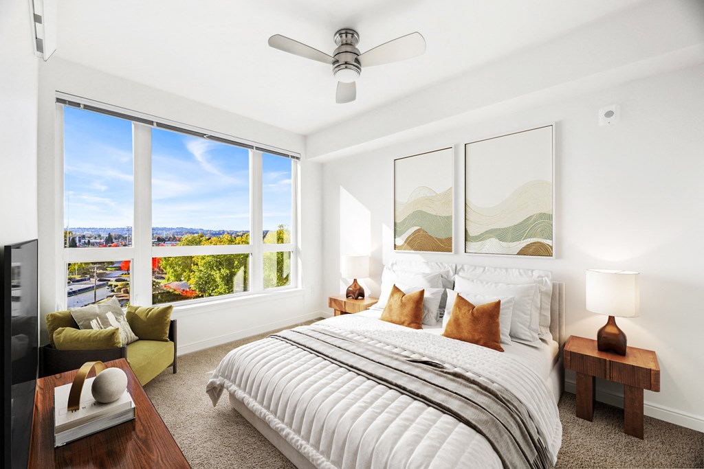 a bedroom with a large bed and a large window