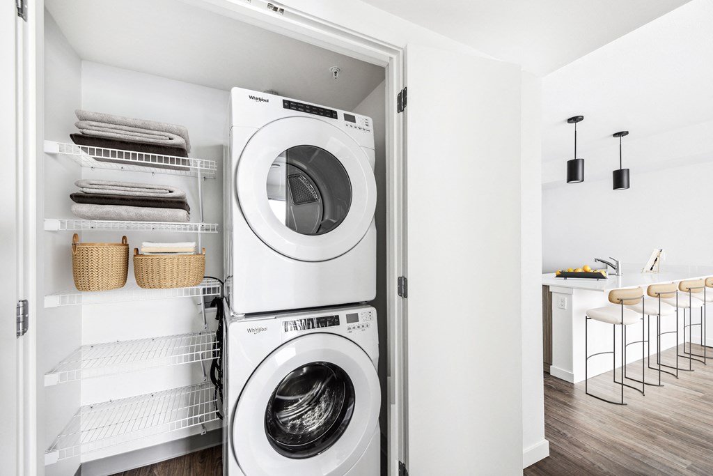 a washing machine and a dryer in a white laundry room