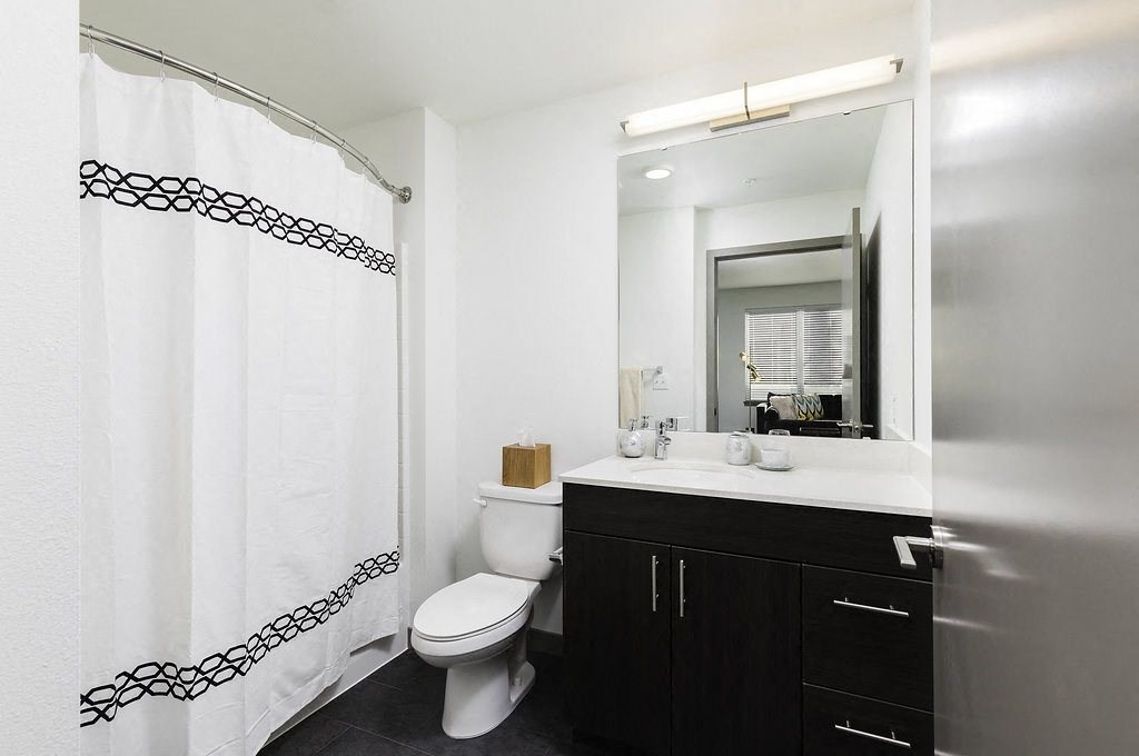 a bathroom with a shower and a sink and a toilet
