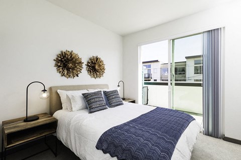 a bedroom with a bed and a large window