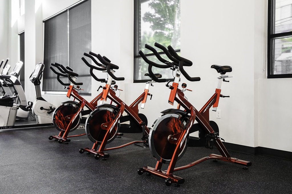 a row of exercise bikes in a gym