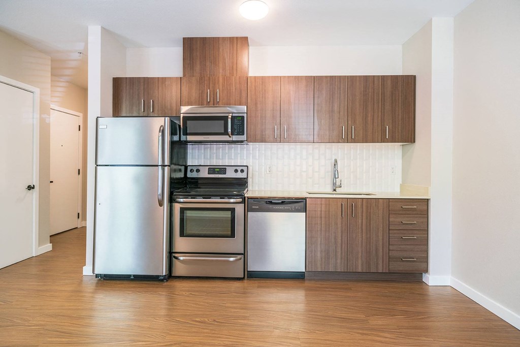 a kitchen with stainless steel appliances and wooden cabinets