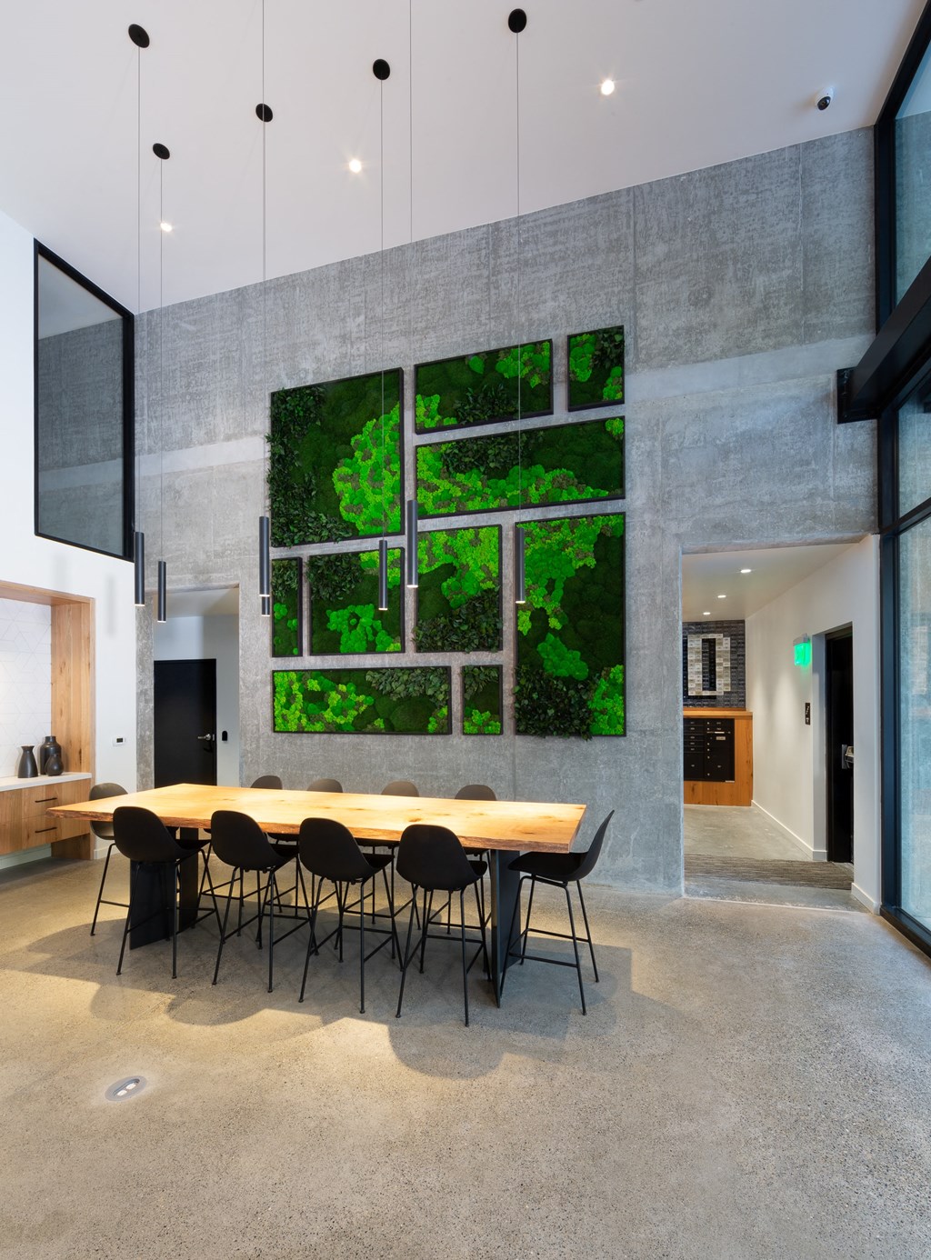 a living wall in a dining room with a table and chairs
