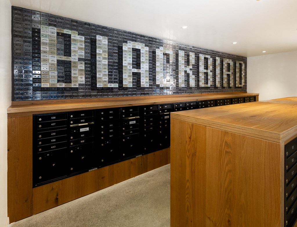 a wine cellar with wooden cabinets and a wooden counter top and a sign that reads