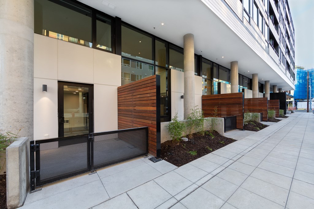 an office building with a wooden facade and a sidewalk