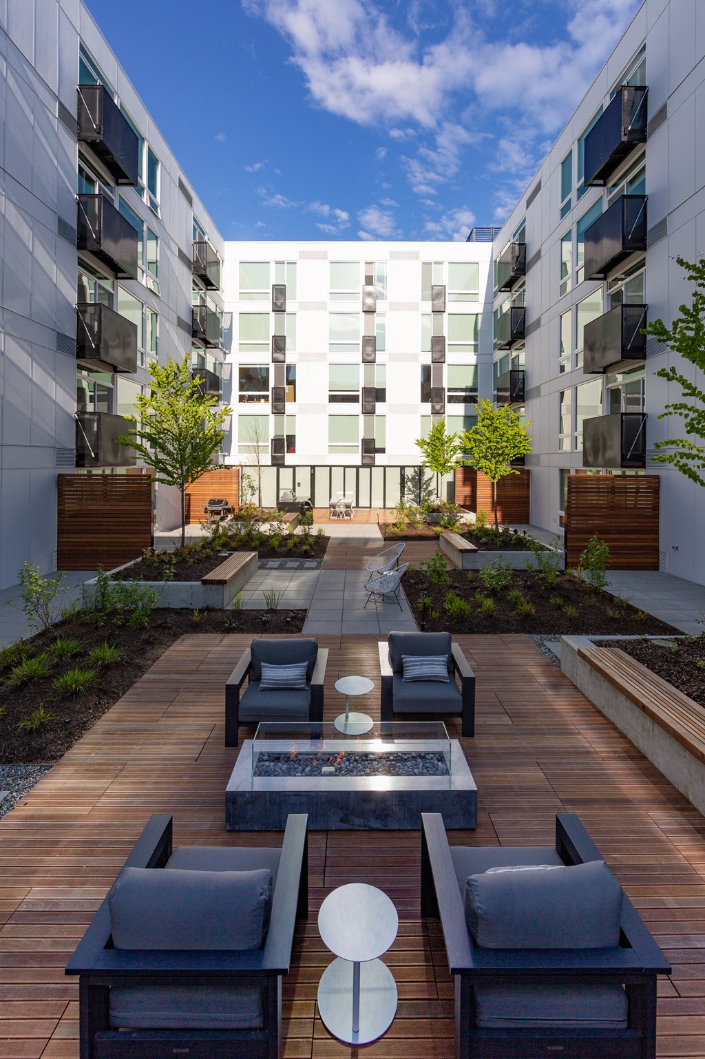 a courtyard with furniture and a fire pit