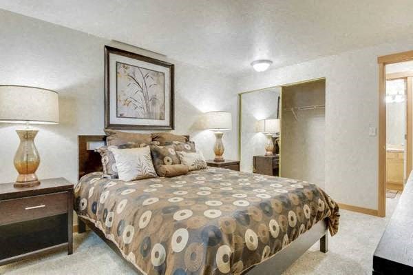 a bedroom with a bed and two lamps