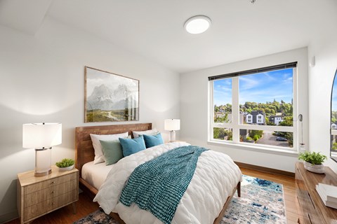 a bedroom with a bed and a large window