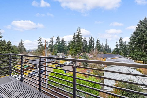 the view from the deck of a rooftop garden with trees