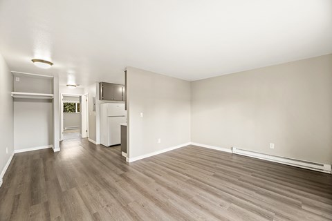 A room with a wooden floor and white walls.