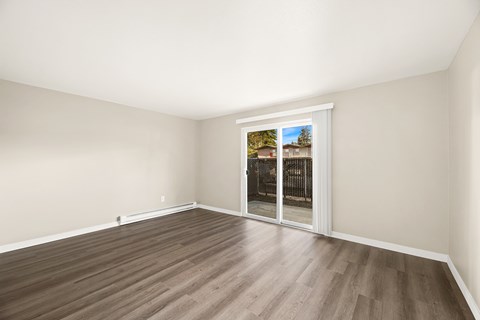 Empty room with a sliding glass door leading outside.