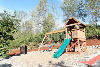 outdoors playground with slide and swings at Copper Creek in Milton WA