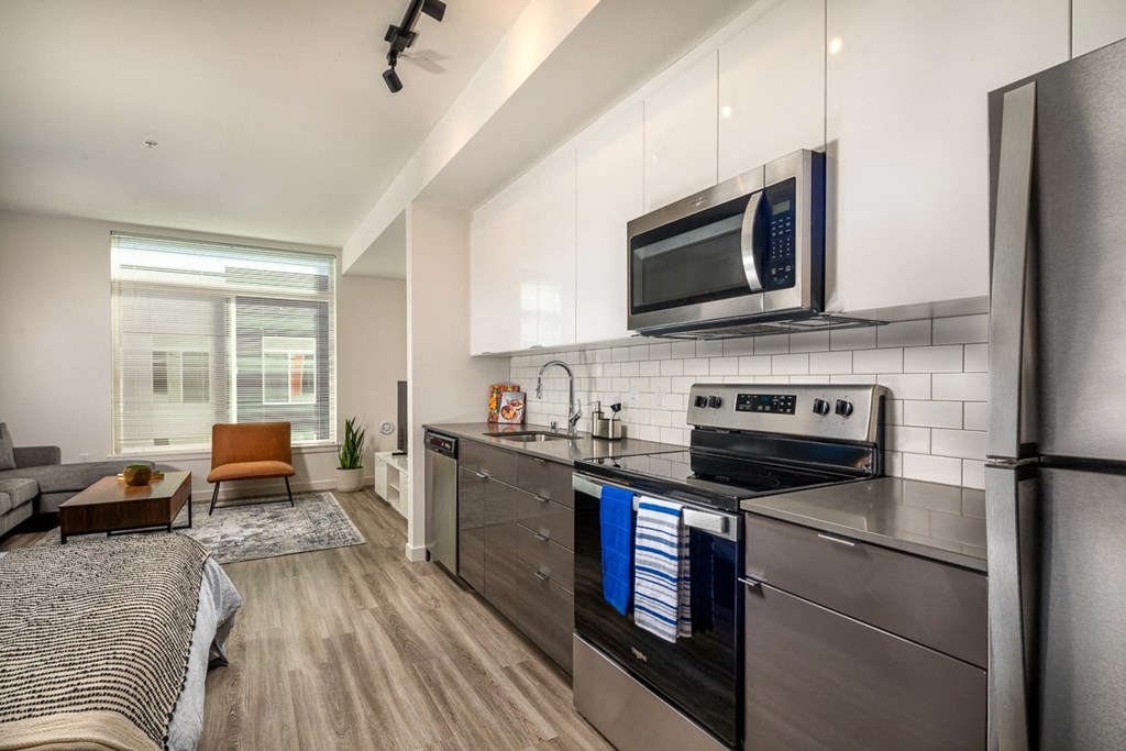 a kitchen with stainless steel appliances and a microwave