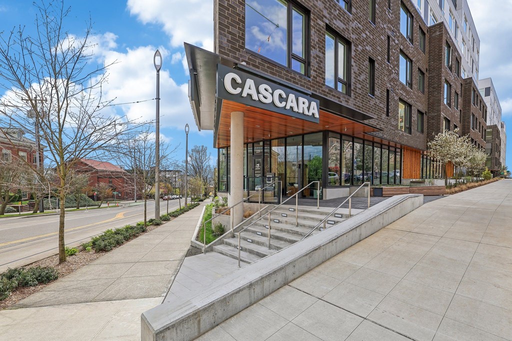 The image shows a modern building with the name "CASCARA" on its facade.