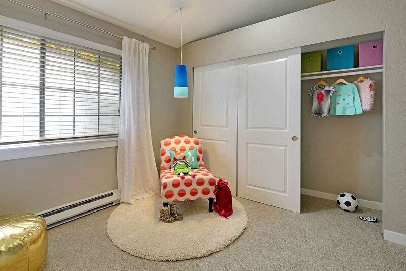 a bedroom with a chair and a closet