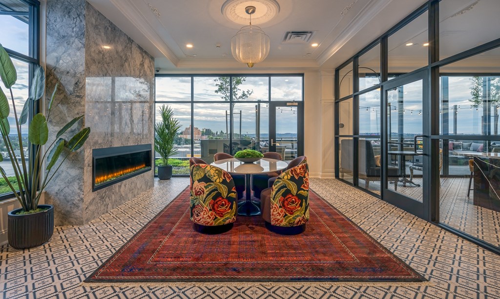 a dining room with a table and chairs in front of a fireplace