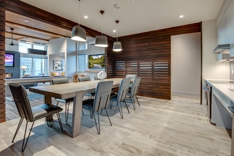 A modern dining room with a wooden table and chairs.