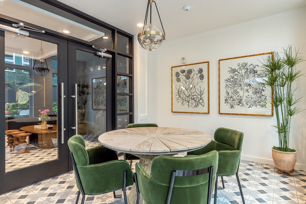 a dining room with a wooden table and green chairs